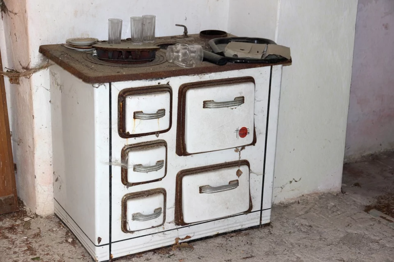 Antique white stove with brown accents and cook top